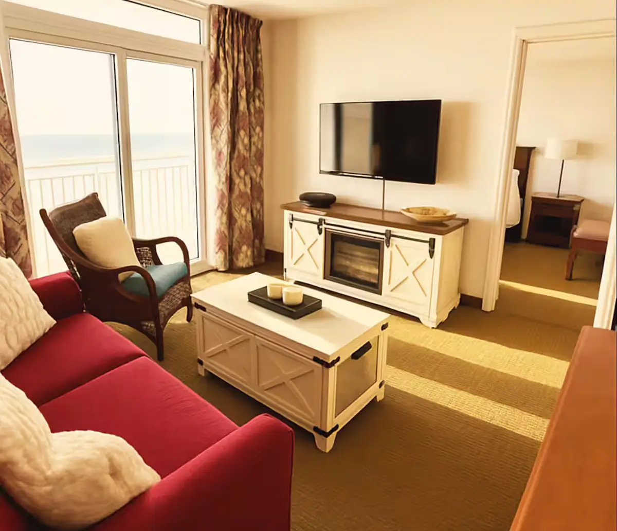 Cozy living room with ocean view balcony.