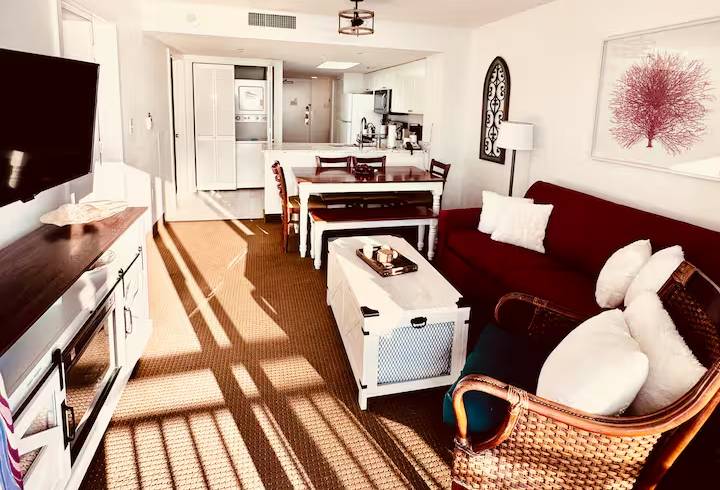 Cozy living room with kitchen and dining area.