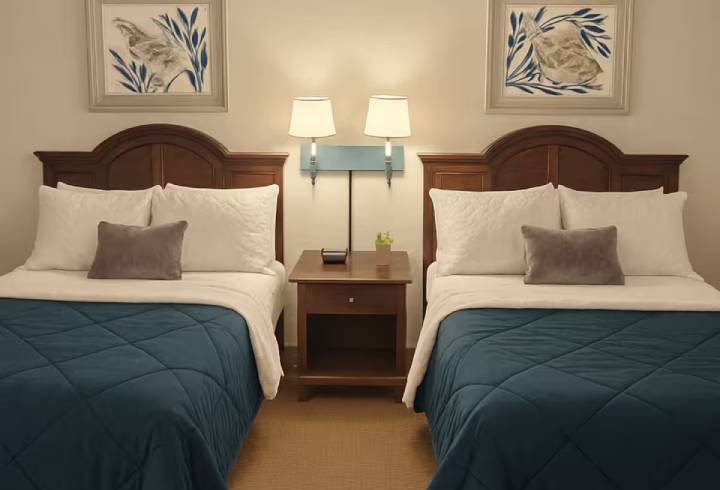 Two beds in a hotel room.