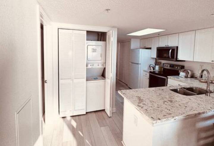 Modern kitchen with laundry area and island.