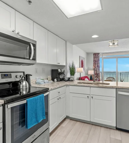 Modern kitchen with ocean view and balcony.