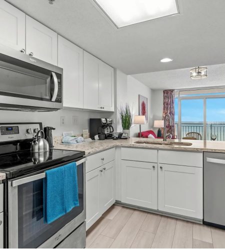 Modern kitchen with ocean view balcony.