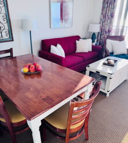 Cozy living room with red sofa, table.