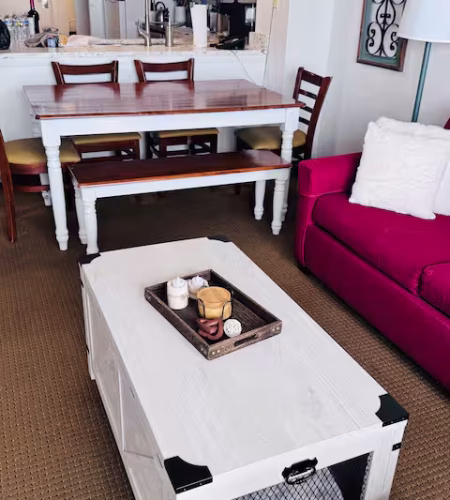 Living room with table and red sofa.