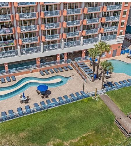 Outdoor pool area at beachfront hotel.