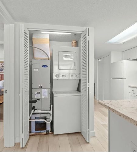 Laundry appliances in compact utility closet.